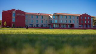 An image of the Torres Hall student apartments from the NMT Athletic Field.